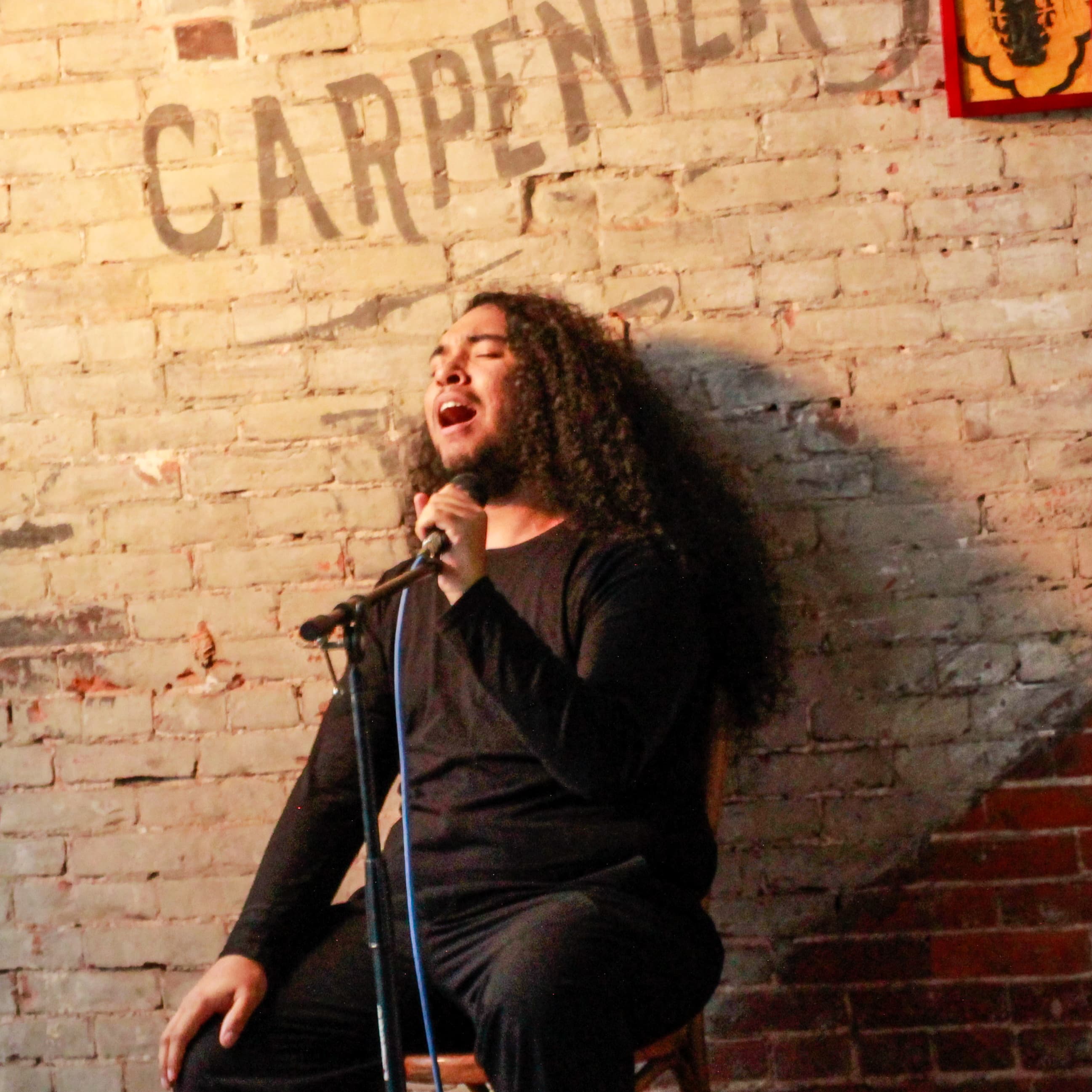 Johnny Kocur playing acoustic guitar with intricate fingerpicking